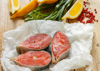 Raw fresh salmon steaks, fresh tarragon, lemon, salt and pepper.