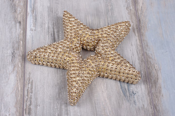 Christmas tree topper decoration golden star isolated on the wooden background