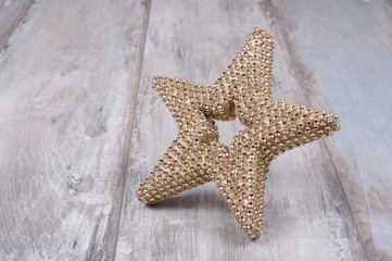 Golden star isolated on the wooden background