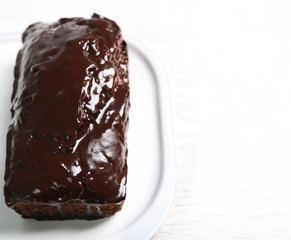 Chocolate cake with icing on white table