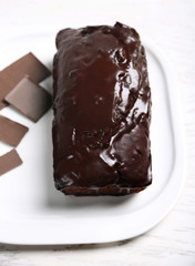 Chocolate cake with icing on white table