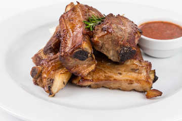 hot smoked barbecue ribs on white plate
