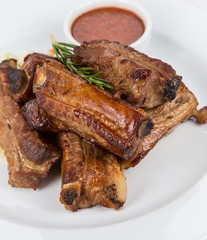 hot smoked barbecue ribs on white plate
