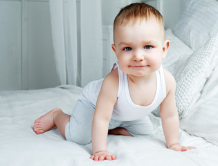 Fototapeta premium cute one year old baby in bed at home