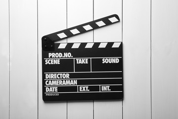 Movie clapperboard on wooden background
