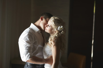 Beautiful young couple kissing with emotional embrace.