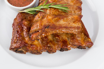 hot smoked barbecue ribs on white plate