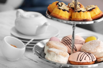 Cake stand with different sweets and tea