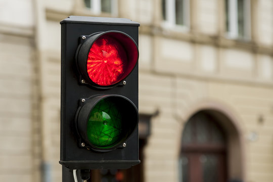 Traffic lights, stop sign on a city street, red light for pedestrians.
