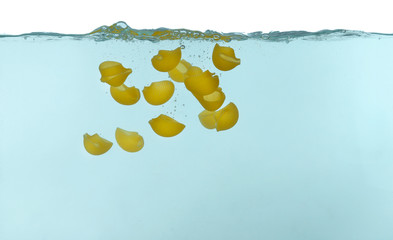 Lumaconi pasta falling in water