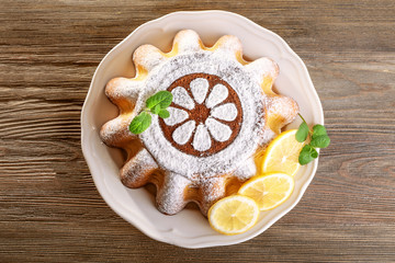 Delicious citrus cake on a white plate with lemons