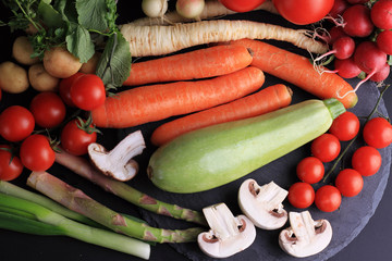Fresh, raw, organic vegetables on black background. Cooking, Healthy eating concept.