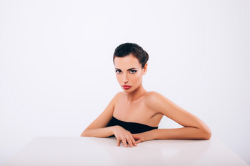 Fototapeta premium Beautiful Skinny Brunette Woman profile portrait. Beauty Luxury Makeup and Black Dress. Gorgeous Fashion Model Girl Portrait Isolated on a white background. 