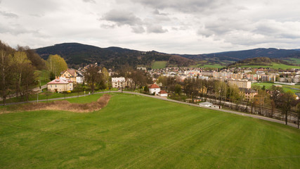 Fototapeta na wymiar Aerial View. Panorama over a green grassy in mountains.