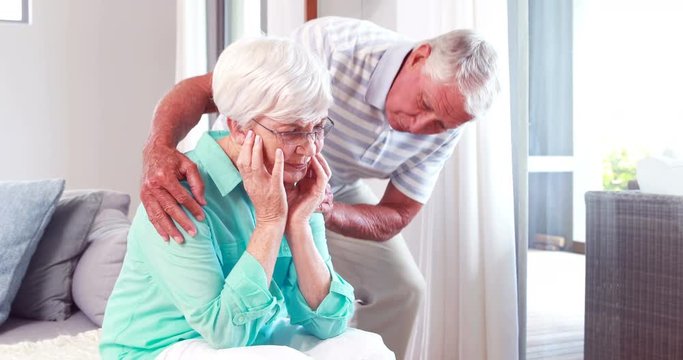 Worried senior man comforting wife