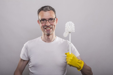 Smiling man with toilet brush