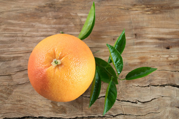 Grapefruit with leaves isolated on wooden background