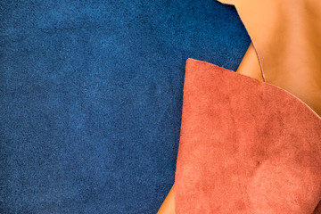 Close up fold suede navy blue and orange leather texture backgro