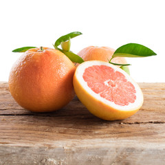 Grapefruit with leaves isolated on wooden background