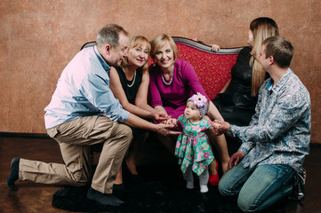 Three Generation Family Sitting On Sofa Together. Classic portrait