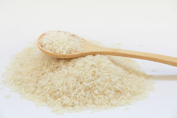 Thai jasmine raw rice in a wooden spoon
