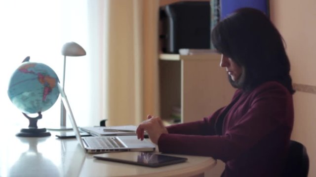woman working on a laptop at home office
