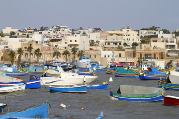 Fototapeta na wymiar Fishing boats in Marsaxlokk harbor, Malta