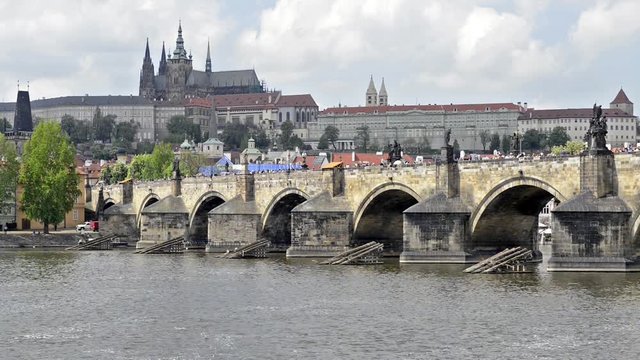 PRAGUE, CZECH REPUBLIC - SUMMER 2015 : Boats on Vltava river, Charles Bridge (Karluv Most), with St. Vitus Cathedral and the Castle district in the background