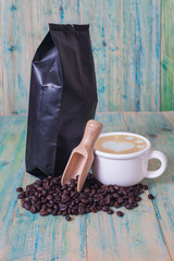 package of coffee beans and hot latte art on the