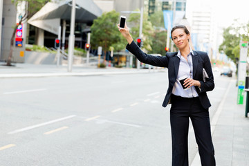 Portrait of business woman catching taxi