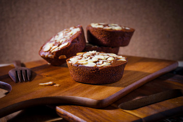 Homemade delicious fresh chocolate and almonds cake on wooden ta