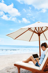 Work At Beach. Successful Business Woman Working Online In Internet Using Laptop Computer Outdoors. Girl Typing On Keyboard While Relaxing By Sea In Summer. Communication Technology Concept
