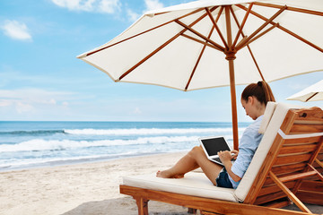 Work At Beach. Successful Business Woman Working Online In Internet Using Laptop Computer Outdoors. Girl Typing On Keyboard While Relaxing By Sea In Summer. Communication Technology Concept