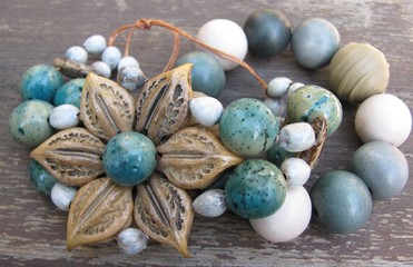 Obraz premium Macro of handmade bracelet made with plants seeds, clay and paper beads