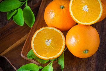 Fresh organic oranges fruits on wooden background.