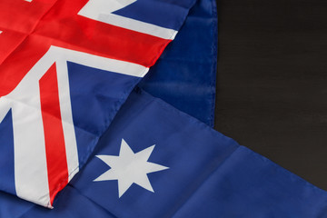 Folded Australian flag on black background with copy space