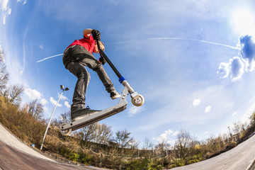 boy jumping with a scooter