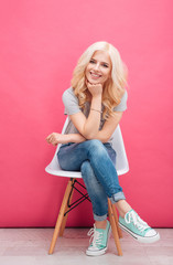 Happy cute woman sitting on the chair
