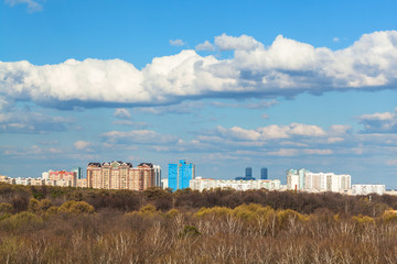 Fototapeta na wymiar blue sky with cloud over city and forest in spring
