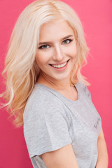 Woman looking at camera over pink background