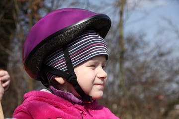 Cute little girl on a bike with her mommy