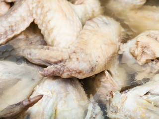many cooked chicken wings in bouillon close up