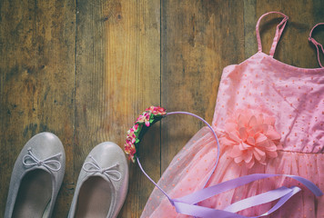 vintage chiffon girl's dress, floral tiara next to ballet shoes