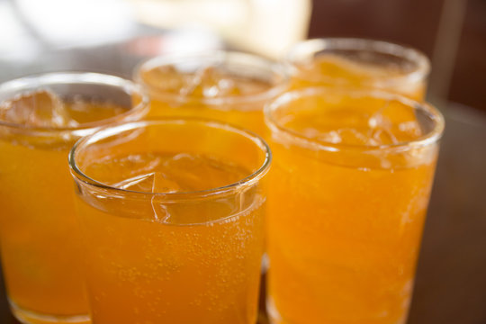 Orange juice with ice in a glass place on the table