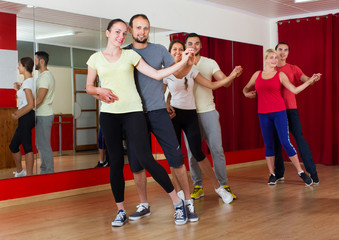 Fototapeta na wymiar Adults dancing in dance studio