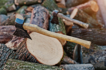 Two axes  in stumps background chopped firewood.