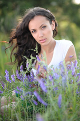 portrait of a beautiful girl with flowers in the summer