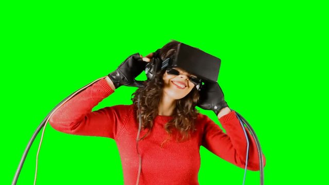 A fast-dancing girl, wearing a virtual reality headset and wired gloves. Pre-keyed chroma-key shot.