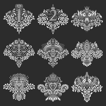 Set of ornamental elements for design in coats of arms form. White floral decorations on black. Isolated tattoo patterns in vintage baroque style.