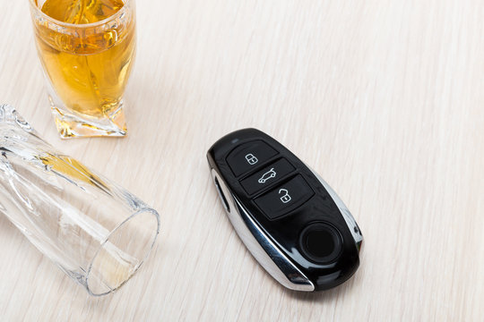 Car key on the bar with spilled alcohol